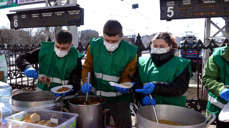 Brīvprātīgie nodrošina bezmaksas siltās maltītes iekšzemē pārvietotajām personām Odesas dzelzceļa stacijā, Ukrainas dienvidos.